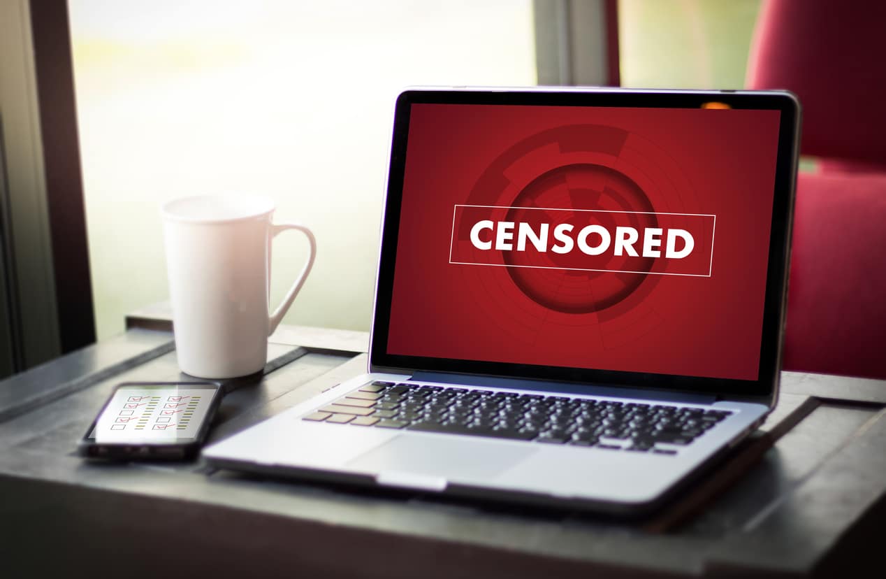 The word "censored" on the screen of a laptop