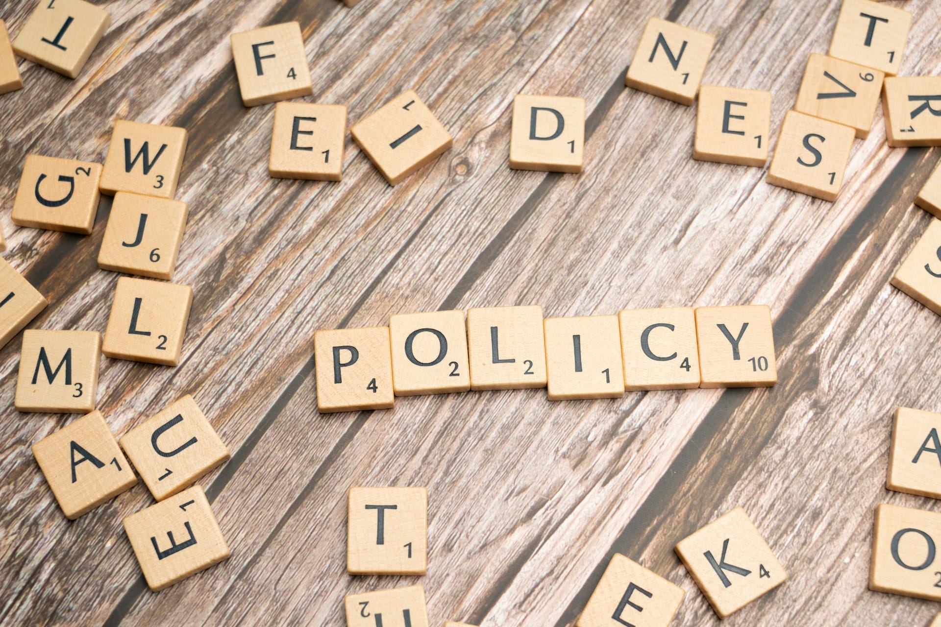 Scrabble tiles spelling out the word "policy"